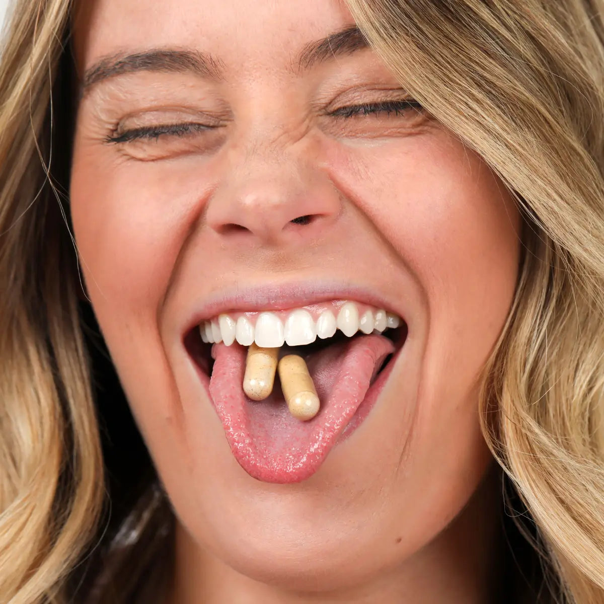 Happy woman taking AndroEase Plus capsules