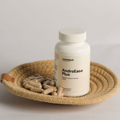 AndroEase Plus PCOS supplement on ceramic plate with whole ingredients like zinc, vitamin B6, and herbal extracts