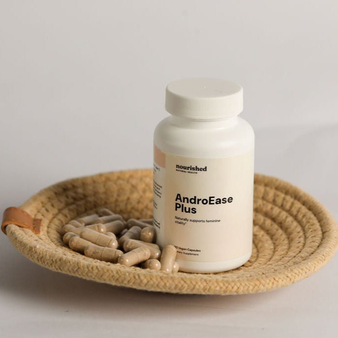 AndroEase Plus PCOS supplement on ceramic plate with whole ingredients like zinc, vitamin B6, and herbal extracts